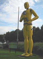 [photo, Oversized replica of yellow crash-test dummy with safety belt, Motor Vehicle Administration, 6601 Ritchie Highway, NE, Glen Burnie, Maryland]